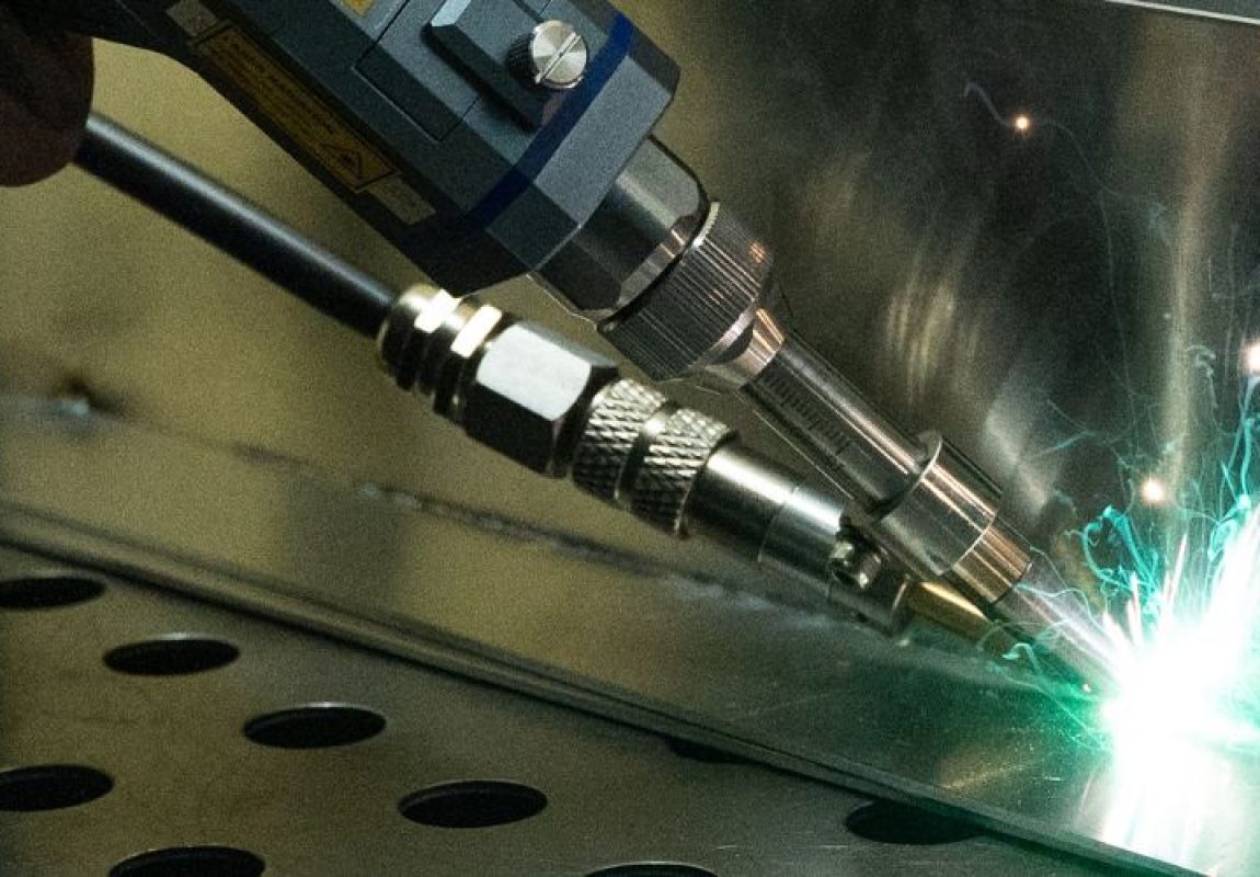 Precision TIG welding on stainless steel panel with bright weld arc